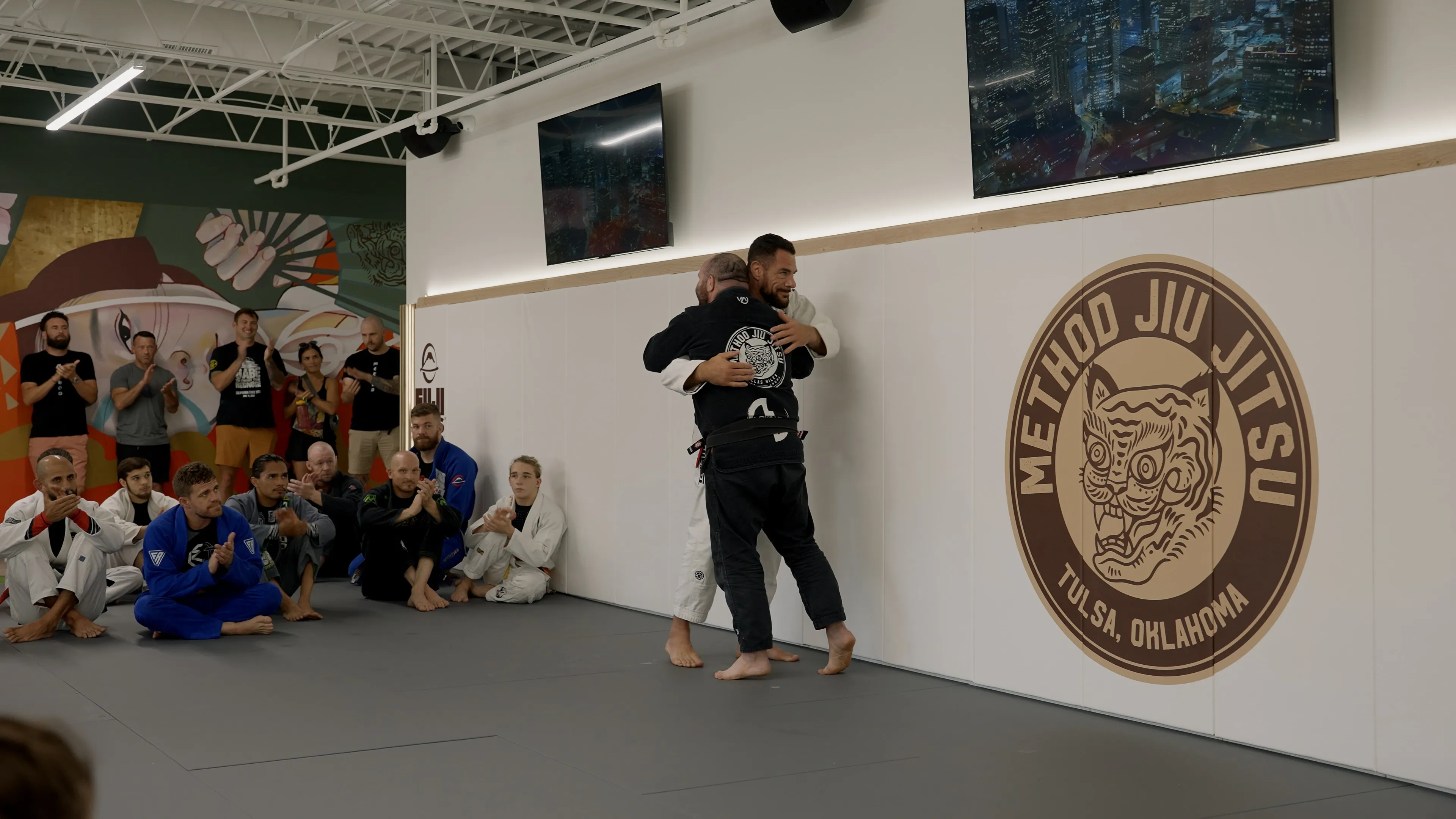 Method Jiu-Jitsu community moment — coach and student after training